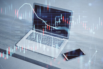 Fototapete - Close up of laptop and smartphone on wooden desktop with glowing candlestick forex chart and map hologram on blurry background. Stock, investment, market and money concept. Double exposure.