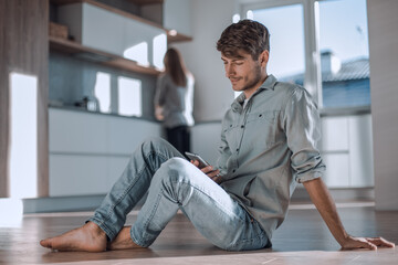 young man reading messages on his smartphone