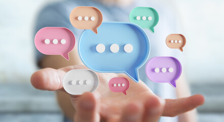 Wall Mural - Businessman using digital speech bubbles talk icons. Minimal conversation or social media messages floating over user hand. 3D rendering