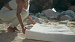 Woman spreading yoga mat on sand beach sunny day close up. Girl ready to workout