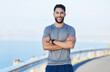 Man athlete, healthy and with cross arms, smile and stand happy outdoor for workout, warm up and wellness..Portrait, confident male and trainer ready for training, fitness and enjoy health exercise.