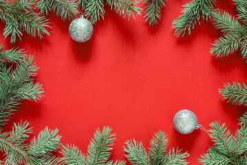 Poster - Christmas red background from green fir branches, frame, top view	