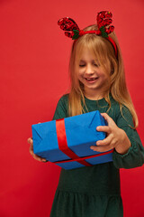 Wall Mural - Smiling funny child (kid, girl) in Reindeer Hairband