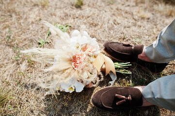 Poster - Beautiful tender wedding bouquet and groom shoes.