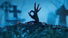 Zombie Hand Makes Okay Gesture Out Of Grave. Holiday Event Halloween Concept