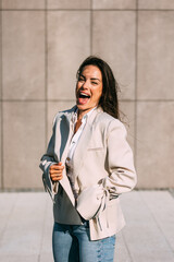 Outdoor lifestyle portrait of cheerful smiling business woman, wearing modern casual elegant outfit