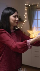 Wall Mural - Vertical Screen: asian woman serving Christmas turkey dish in plate and letting her husband smell the aroma while they are getting ready for festive dinner at home