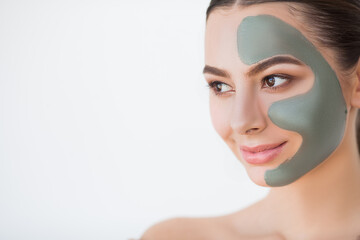 Female face with perfect skin and gray spa mask.