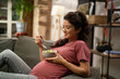 Pregnant woman eating fuit at home. Beautiful pregnant woman enjoy in healthy meal..