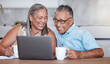 © Beaunitta Van Wyk/peopleimages.com - Movie, internet and senior couple streaming a video on social media with coffee in house. Happy elderly man and woman with laptop for subscription service and tea to relax while watching comic show