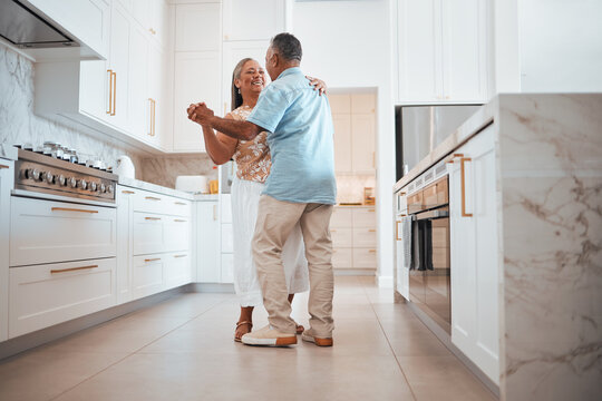 couple, elderly and dance in kitchen for love, romance and happy together while home in retirement. 