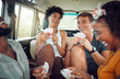 © K Abrahams/peopleimages.com - Friends, car road trip and game of card for diversity group of people bond and enjoy quality vacation time together. Transport travel, freedom smile and happy gen z students play fun match on holiday