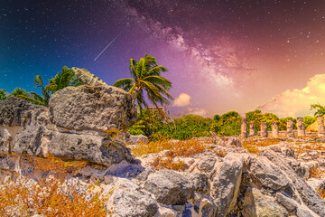 Iguana lizard in ancient ruins of Maya in El Rey Archaeological Zone near Cancun, Yukatan, Mexico with Milky Way Galaxy stars night sky