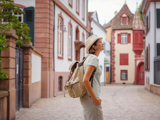 travel to summer Europe young asian woman. Woman having a great vacation in Switzerland, Basel. Lady visiting tourist attractions and landmarks.