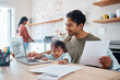 © Nina Lawrenson/peopleimages.com - Man, baby or laptop finance in house or home kitchen and insurance paper, investment documents or fintech accounting software. Happy smile, asian father and down syndrome boy, son and child with tech