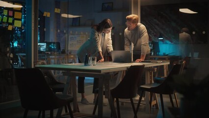 Aufkleber - Successful Young Small Business Owners Communicating at a Meeting in Office at Night. Beautiful Female and Handsome Male Discussing Corporate Agenda and Opportunities. Managers High Five Each Other.