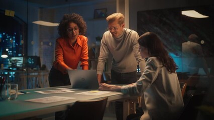 Poster - Group of Young Successful Businesspeople Making a Team Meeting in Conference Room in Creative Agency. Excited Diverse Team Using Laptop Computer, Discussing a New Corporate Strategy.
