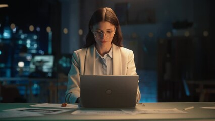 Poster - Stylish Female in Glasses Working on Laptop Computer in a Company Office in the Evening. Young Manager Browsing Internet, Shopping Online and Reading Social Media Posts from Friends and Colleagues.