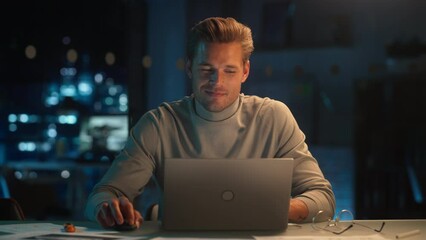 Poster - Portrait of a Stylish Male Working on Laptop Computer in a Company Office in the Evening. Young Manager Browsing Internet, Shopping Online and Reading Social Media Posts from Friends and Colleagues.