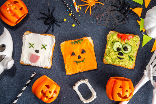 Kids food, party or breakfast Halloween idea. Simple healthy sandwiches recipe from toast bread, avocado, cream cheese, pumpkin spread with Halloween monster decor