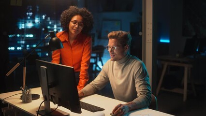 Aufkleber - Project Manager Working on Desktop Computer in Office at Night. Young Multiethnic Specialist Comes Over to the Desk to Discuss Business Development Opportunities and Marketing Campaign.