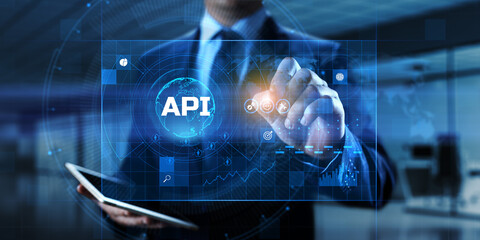 API Application programming interface. Businessman pressing virtual button.