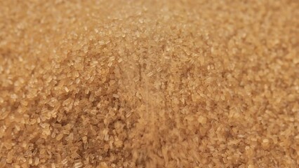Poster - Pouring brown sugar close up. Demerara golden brown sugar