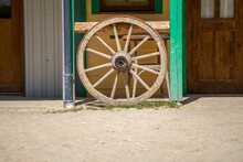 Closeup Shot Of A Wooden Wagon Wheel As An Outdoor Decoration On A Sunny Day
