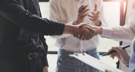 Business handshake for teamwork of business merger and acquisition,successful negotiate,hand shake,two businessman shake hand with partner to celebration partnership and business deal concept