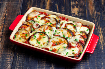 Baked eggplant with cheese mozzarella and tomatoes. Healthy eating. Italian food. Parmigiana di melanzane.