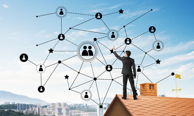 businessman on house roof presenting networking and connection concept. mixed media