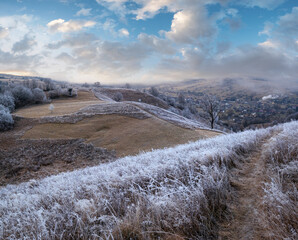Wall Mural - winter coming. picturesque pre sunrise scene above late autumn mountain countryside with hoarfrost o