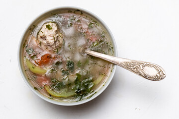 Wall Mural - Vegetable soup with meatballs in a plate on a white background.