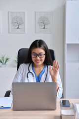 Young Asian female doctor using computer laptop talking video conference call