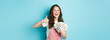 © Mix and Match Studio - Smiling happy woman holding money, dollar bills and showing thumb up, recommending fast cash loan and looking satisfied, standing over blue background