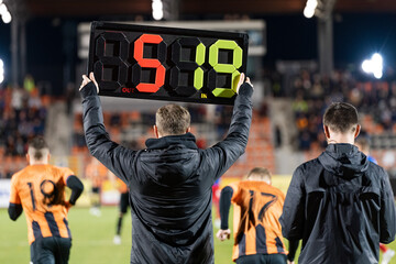 Wall Mural - Man shows players substitution during football match.