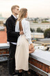 Beautiful happy young loving couple on a surprise date on a Saint Valentine's Day. Romantic modern wedding on the rooftop, summertime. Young man and beautiful girl. Newlyweds on honeymoon