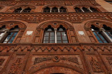 Wall Mural - Beautiful colored vintage art red brick building facade. European architecture. Journey to Italy