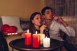 © maryviolet - Valentines Day couple in love drinks champagne with strawberries having romantic dinner celebrating at home