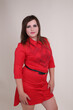 beautiful fashionable young plump fat big oversize girl model on the studio with piercings in a red dress