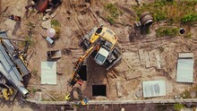 Demolition Construction Working Site. An Excavator Performing Lifting Operations. Underground Pipe Work. Warsaw. Top Drone View. High Quality 4k Footage