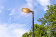Modern lamppost with LED lamp on a summer day in a public park against the sky