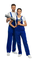 Poster - Professional workers in uniform with putty knives on white background