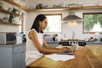 Fototapete - Search, communication and laptop with woman in kitchen and remote work with internet, contact and review. Email, technology and research with girl typing at home for innovation, vision and report