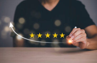 The concept of placing rating. Businessman touching technology on five star excellent rating on blue background, Concept of satisfaction, quality and performance of services.Copy space for web banner.