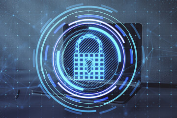 Poster - Close up of laptop on desktop with creative glowing blue padlock hologram on blurry background. Secure, safety, database and web protection concept. Double exposure.