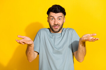 Canvas Print - Portrait photo of young nervous excited bearded brunet guy dont know shrug shoulders palms no idea how works mechanism isolated on yellow color background