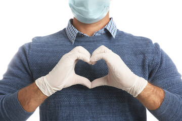 Canvas Print - Man in protective face mask and medical gloves making heart with hands on white background, closeup