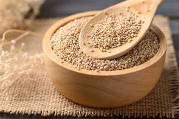 Wall Mural - Brown quinoa seed in wooden bowl with spoon, Super food