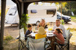 © Johnér - Family sitting at picnic table